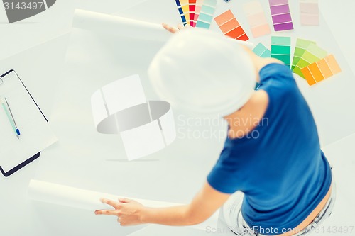 Image of woman with color samples and blueprint