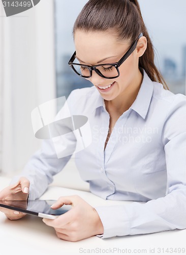 Image of smiling businesswoman in eyeglasses with tablet pc