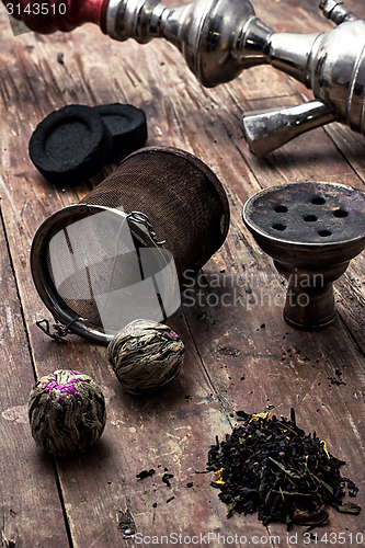 Image of hookah and dry elite tea leaves