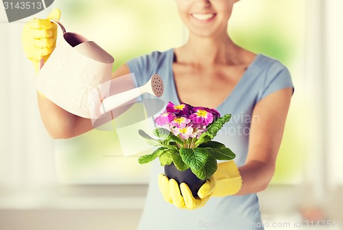 Image of woman holding pot with flower