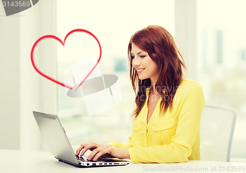 Image of smiling student with laptop computer at school