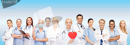 Image of smiling doctors and nurses with red heart