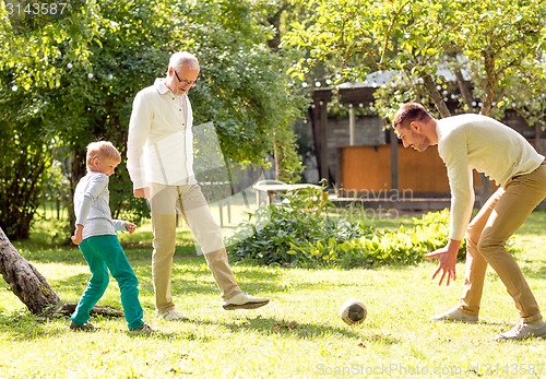 Image of happy family playing football outdoors