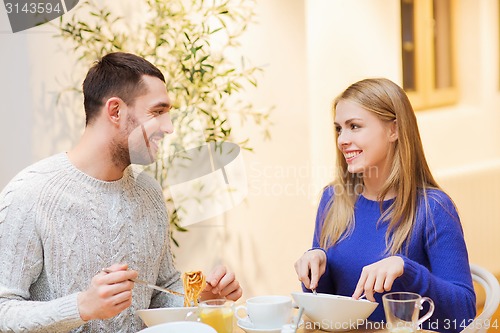 Image of happy couple meeting and having dinner at cafe