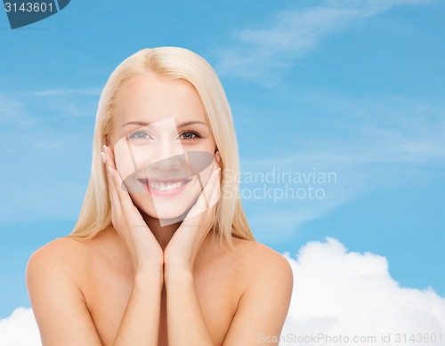 Image of beautiful woman touching her face skin