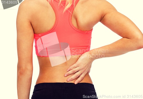 Image of close up of sporty woman touching her back