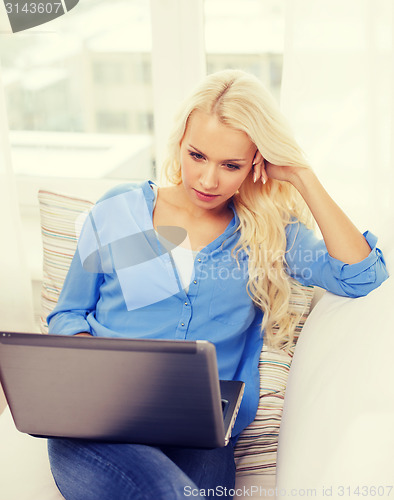 Image of woman with laptop computer at home