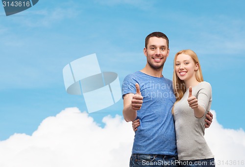 Image of smiling couple showing thumbs up