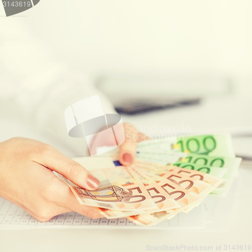 Image of woman hands with euro cash money