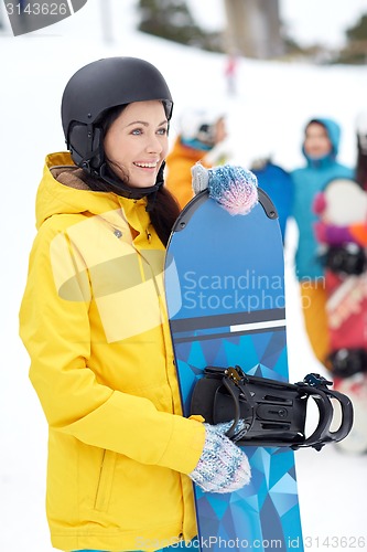 Image of happy friends in helmets with snowboards