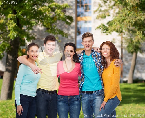 Image of group of smiling teenagers over campus background