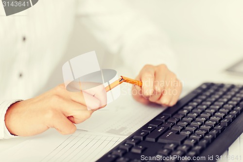 Image of woman breaking pencil