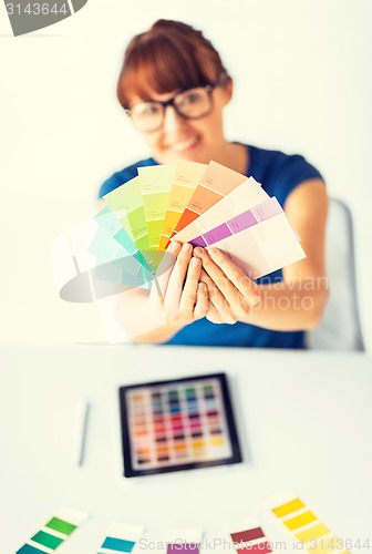 Image of woman showing pantone color samples