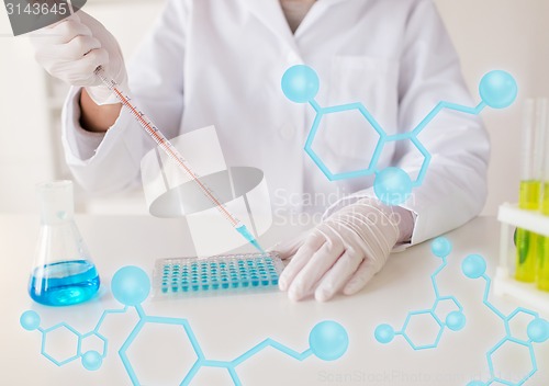 Image of close up of scientist making test in lab