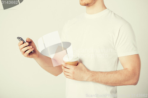 Image of man with smartphone and coffee