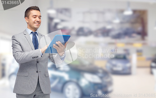 Image of happy businessman in suit with tablet pc