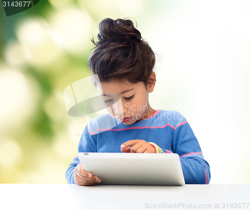 Image of little girl with tablet pc over green background