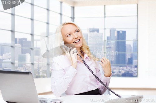 Image of smiling businesswoman calling on telephone