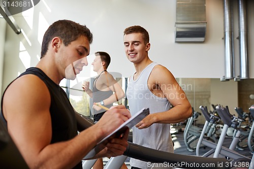 Image of men exercising on treadmill in gym