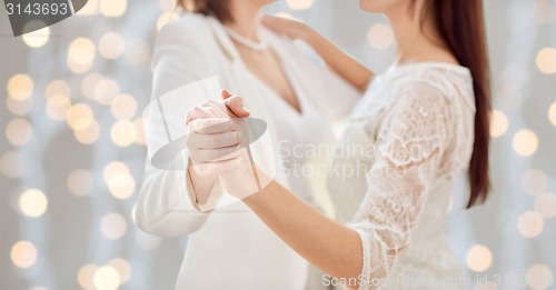 Image of close up of happy married lesbian couple dancing