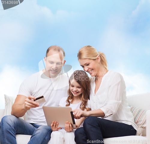 Image of happy family with tablet pc and credit card