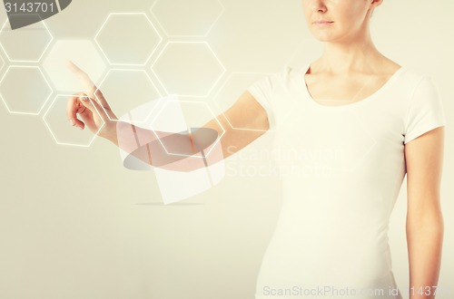 Image of woman hand pressing virtual button