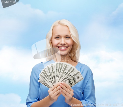 Image of smiling young woman with us dollar money