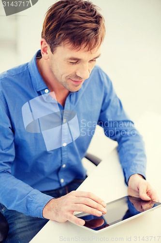 Image of man working with tablet pc at home