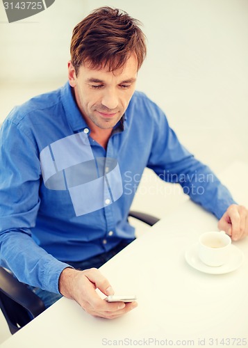 Image of buisnessman with smartphone and cup of coffee