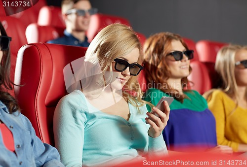 Image of happy woman with smartphone in 3d movie theater