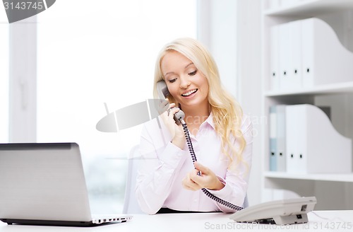 Image of smiling businesswoman or student calling on phone