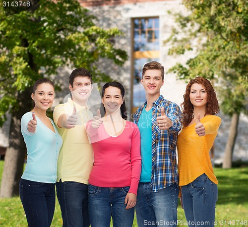 Image of group of smiling teenagers over campus background
