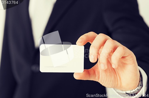 Image of businessman showing blank card