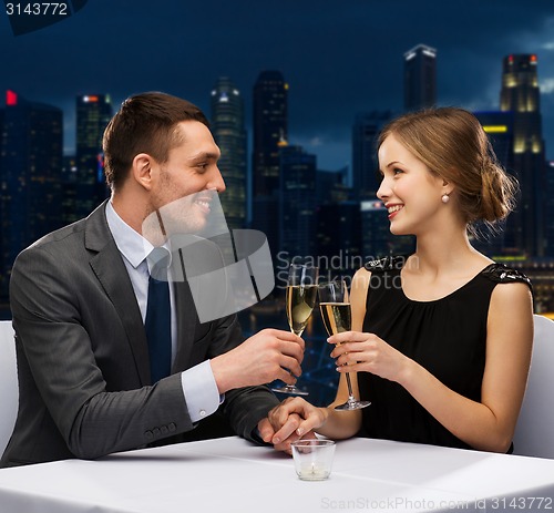 Image of couple with glasses of champagne at restaurant