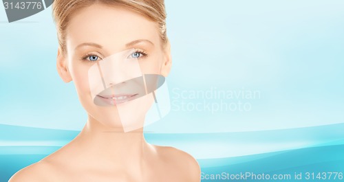 Image of beautiful young woman face over blue background
