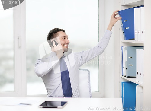 Image of businessman with smartphone and tablet pc