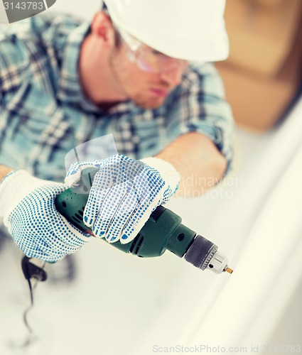 Image of man drilling the wall