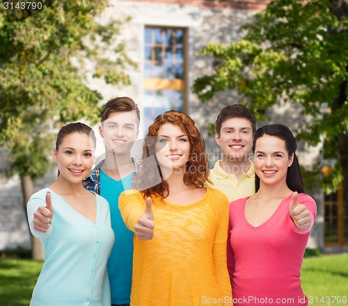Image of group of smiling teenagers over campus background