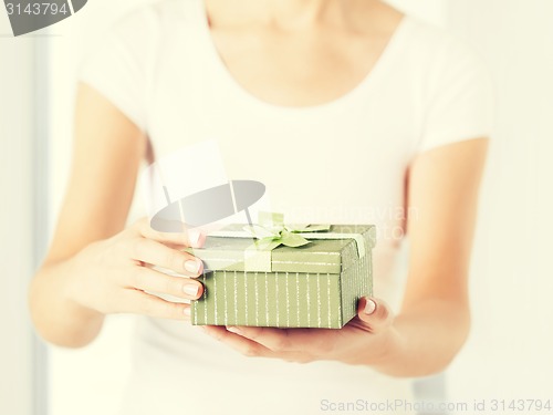 Image of woman hands with gift box