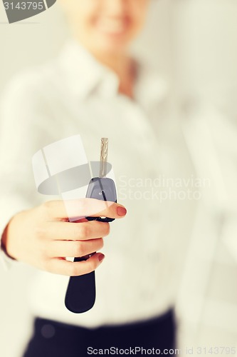 Image of woman hand holding car key