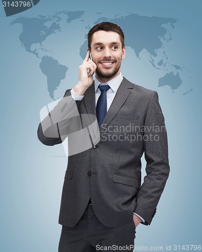 Image of young smiling businessman with smartphone