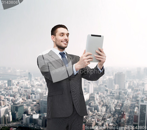 Image of smiling buisnessman with tablet pc computer