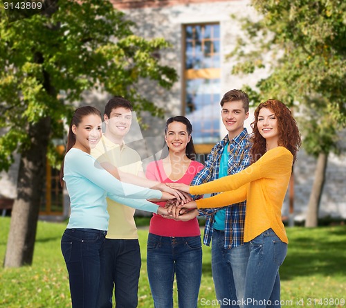 Image of group of smiling teenagers over campus background