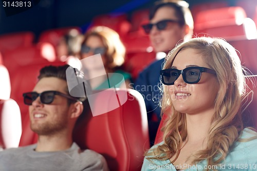 Image of happy friends watching movie in 3d theater