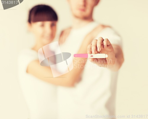 Image of woman and man hands with pregnancy test