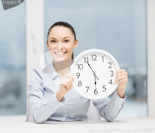 Image of attractive businesswoman with white clock