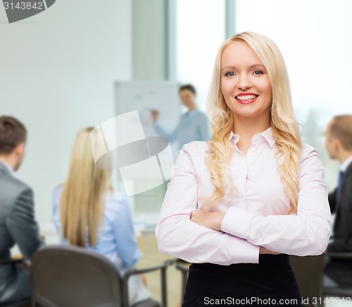 Image of smiling businesswoman or secretary in office