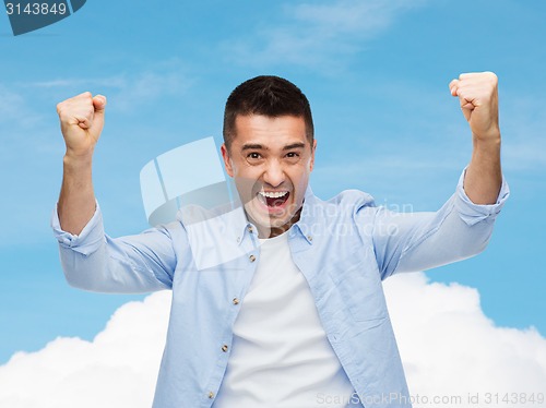 Image of happy laughing man with raised hands
