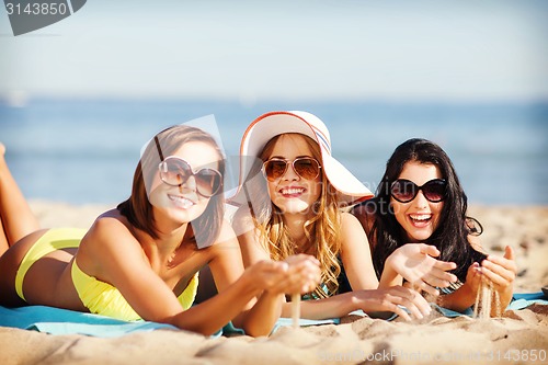 Image of girls sunbathing on the beach