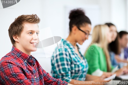 Image of student with computer studying at school